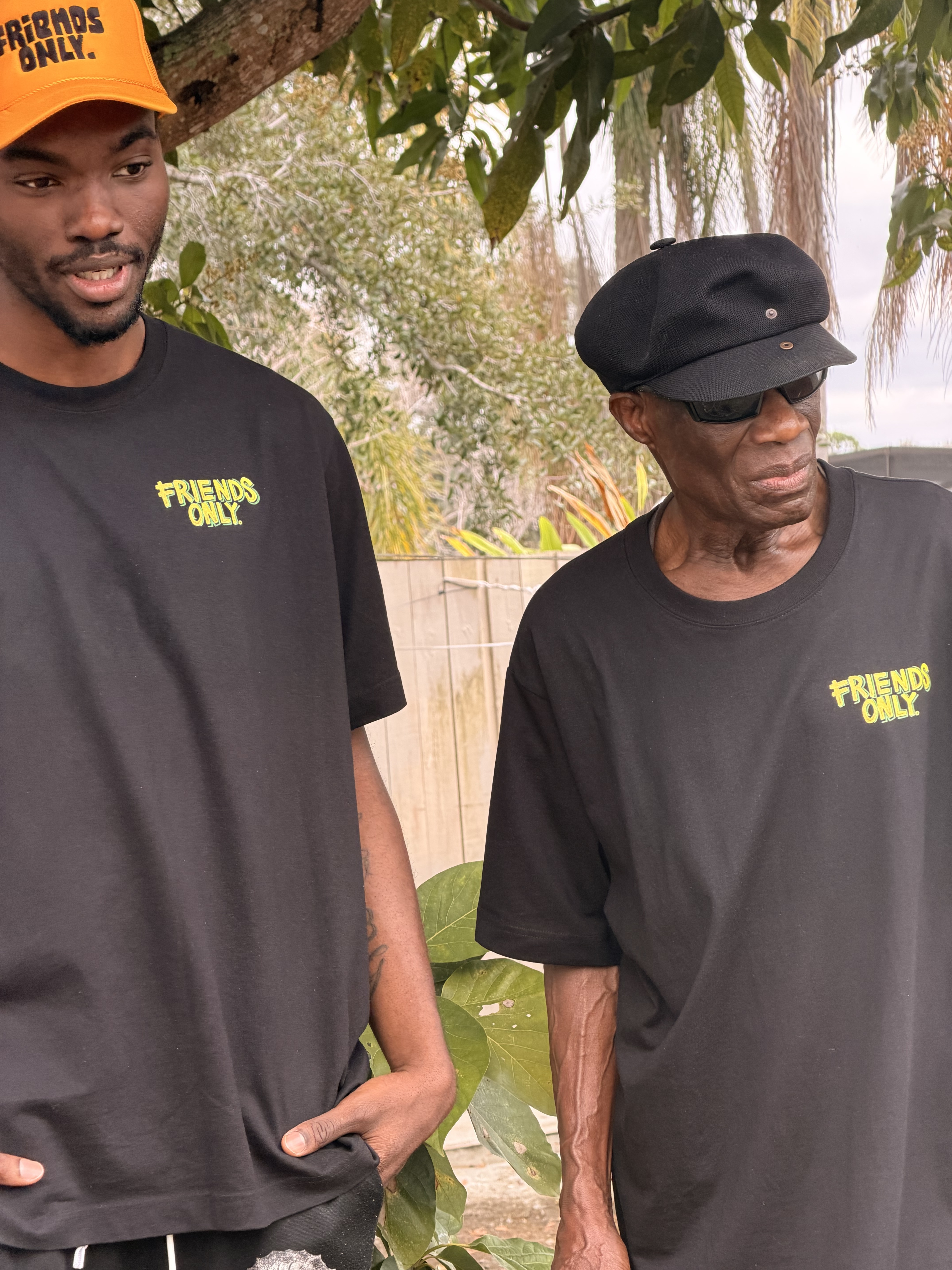 Emil and Grandpa standing in FO tees